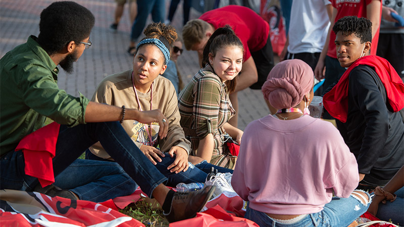 Outdoor photo of students sitting together